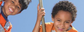 Photo: Two boys climbing a jungle gym.