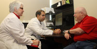 Cancer patient Scott Sandness meets with his patient navigator, Deb White, RN, and oncologist, Jorge Nieva, MD, at Billings Clinic Cancer Center in Billings, Mt.