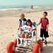 photo - children on beach with child using beach wheelchair
