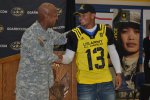 Brig. Gen. Henry Huntley, deputy commanding general, U.S. Army Recruiting Command, shakes hands with running back Thomas Tyner from Aloha High School in Portland, Ore.