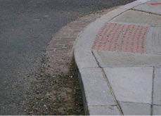 Case Study: Photo of retrofitted curb ramp that extends through the width of the gutter.