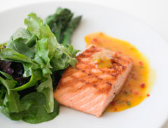 Salmon filet with salad on a plate