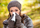 A woman blows her nose