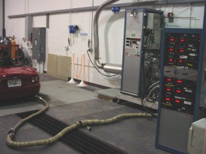 Photo: Hose connected to vehicle tailpiple; sending emissions to test equipment
