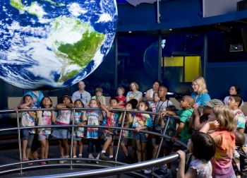 Students and teachers explore global data visualizations with NOAA’s Science On a Sphere at the Chicago Museum of Science and Industry (MSI).  The sphere will serve as a focal point for K-12 teacher professional development programs at MSI, which is one of eight new recipients of NOAA Environmental Literacy Grants.  (Photo credit:  MSI)