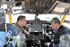 U.S. Ambassador to South Africa Donald H. Gips sits in a KC135T Stratotanker cockpit with Michigan Air National Guard aircraft commander Lt. Col. Paul Beck