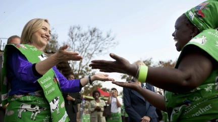 Date: 08/05/2012 Description: Secretary of State Hillary Rodham Clinton dances with Emille Phiri, chair of the Lumbadzi Milk Bulking Group, at the end of the Secretary's visit to the group in Lilongwe, Malawi. © AP Image