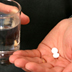 Photo of aspirin in a hand.