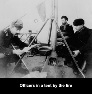 Officers in tent by fire keeping warm & eating