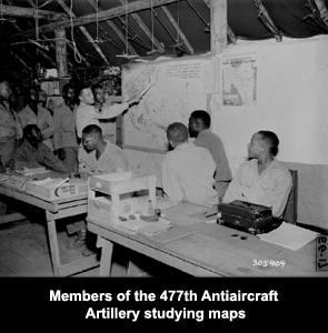 Members of the 477th Antiaircraft Artillery studying maps