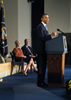 a photo of President Obama speaking at a podium, with Secretary Sebelius and Dr. Collins seated in the background.