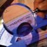 Magnifying glass over identification documents.