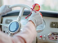 trivia quiz are you a smart driver woman's glved hands on vintage car steering wheel, red glasses