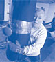 Image of a man holds on to punching bag