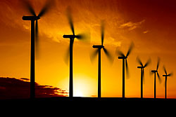 Photo is a silhouette of seven wind turbines