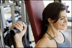 woman using weight machine