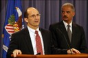 FBI Deputy Director Sean Joyce (at podium) and Attorney General Eric Holder announce charges at a press conference in Washington, D.C. against 107 individuals, including doctors, nurses, and other licensed medical professionals, for their alleged participation in Medicare fraud schemes involving approximately $452 million in false billing—the highest amount in a single takedown in Medicare Fraud Strike Force history. For more information, see http://www.fbi.gov/news/news_blog/strike-force-takedown-050212.