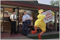 Watch the Chicken commercial in Windows Media format. Screenshot of Every Door Direct Mail commercial, showing someone in a chicken costume dancing and holding a sign in front of a restaurant while Al the mail carrier delivers mail to the restaurant owner.
