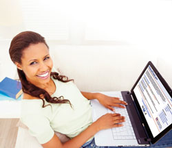 A woman looking at clinicaltrials.gov on her laptop