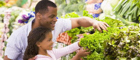 photo of father and daughter at produce market