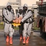 Individuals in hazmat suits. 