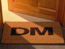 Image of a welcome mat that says DM