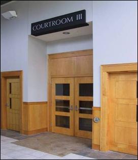 Courtroom entrance with automatic door operator that has controls located outside door swing