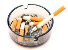 Photo of ashtray filled with cigarette stubs.
