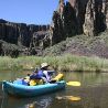 Inflatable boat on river with mountain in background