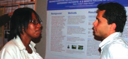 photo of two researchers in front of a scientific poster presentation