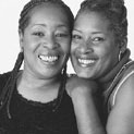 A black and white close up photo of two African American women, Joan and Bonnie smiling.