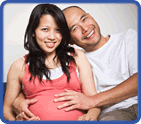 smiling pregnant woman and man