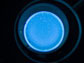 image of a petri dish illuminated with blue light
