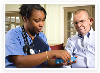 A home health care worker goes over medications with her senior patient