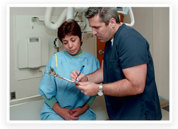 A doctor reviews paperwork with a patient before taking x-ray