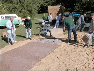 Figure 4—Leveling and compaction of binder–EWF mixture near junction with asphalt path.