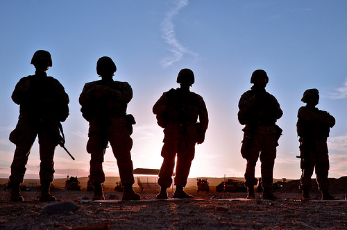 US Marines silhouetted against the sunset.