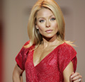 Talk show host Kelly Ripa walks the runway in a designer red dress