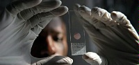 Date: 06/22/2011 Description: A laboratory technician in Tanzania prepares a blood smear. © AFP Image