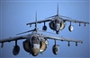 Two U.S. Marine Corps AV-8 Harriers fly in formation 