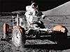 An astronaut sits in a lunar rover on the moon