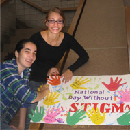 photo of two female students displaying a poster