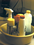 Bottles of cleaners in a container
