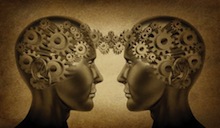 Two heads showing brains as gears that are interconnected through space