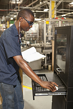Factory employee at computer