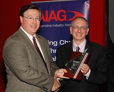 Howard Harary (right), director of NIST's Manufacturing Engineering Laboratory, accepts the Automotive Industry Action Group's Chairman's Award from AIAG Chair Brian Vautaw.