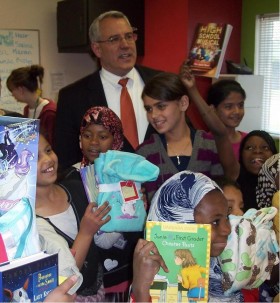 Boise Mayor Bieter greets schoolchildren with books and pajamas.