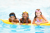 A group of children swimming in a pool.