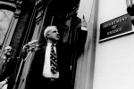 Dr. James R. Schlesinger, the first Secretary of Energy, unveils the signplate at the Energy Department's temporary headquarters on October 1, 1977.