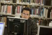 Man looking at computer in library